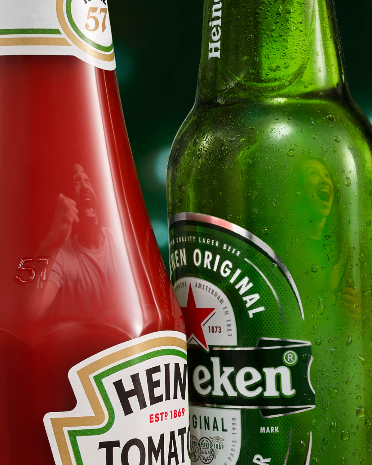 Close-up of Heineken beer bottle and Heinz tomato ketchup bottle with visible branding.