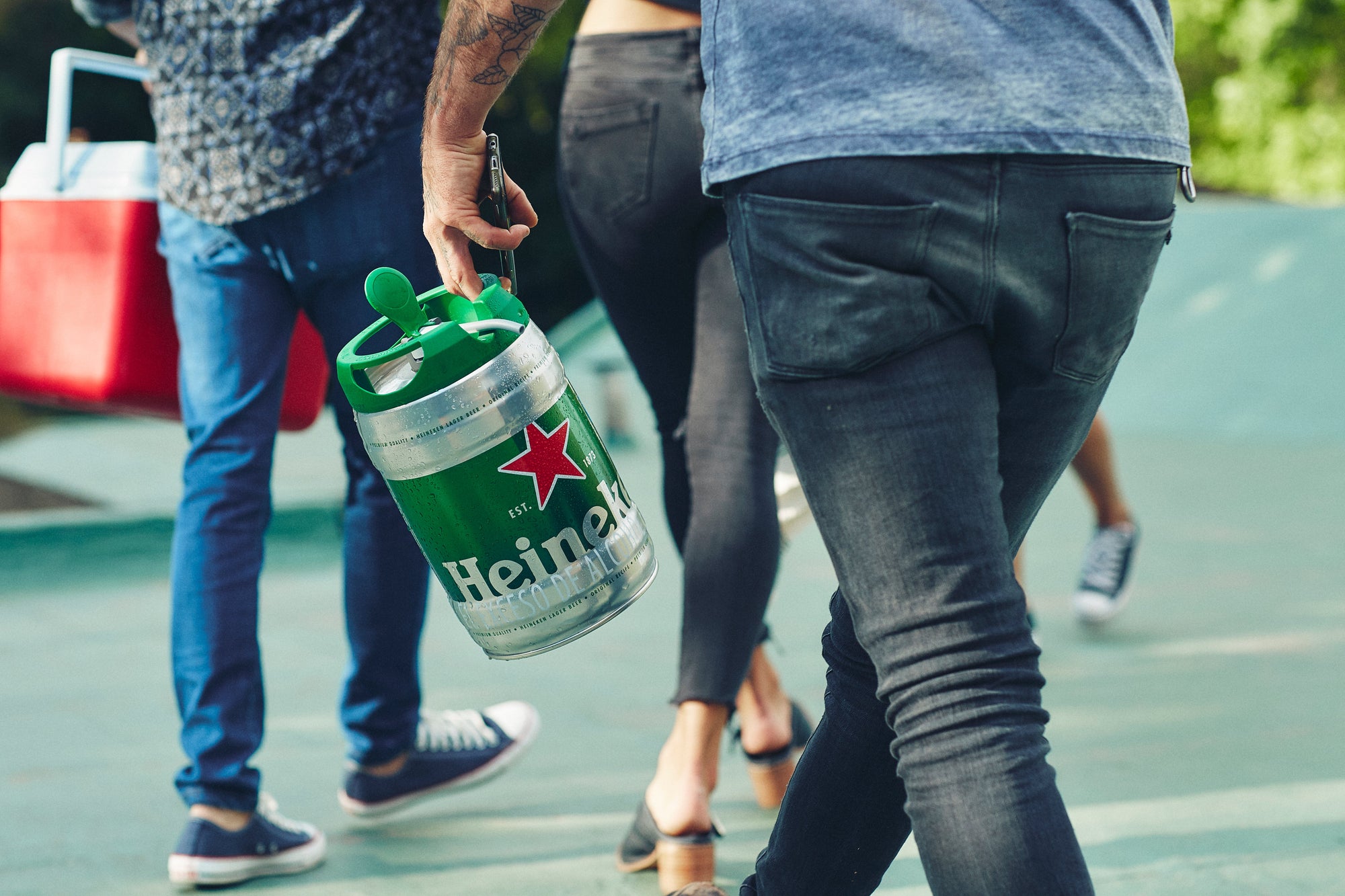 Person carrying a Heineken keg 