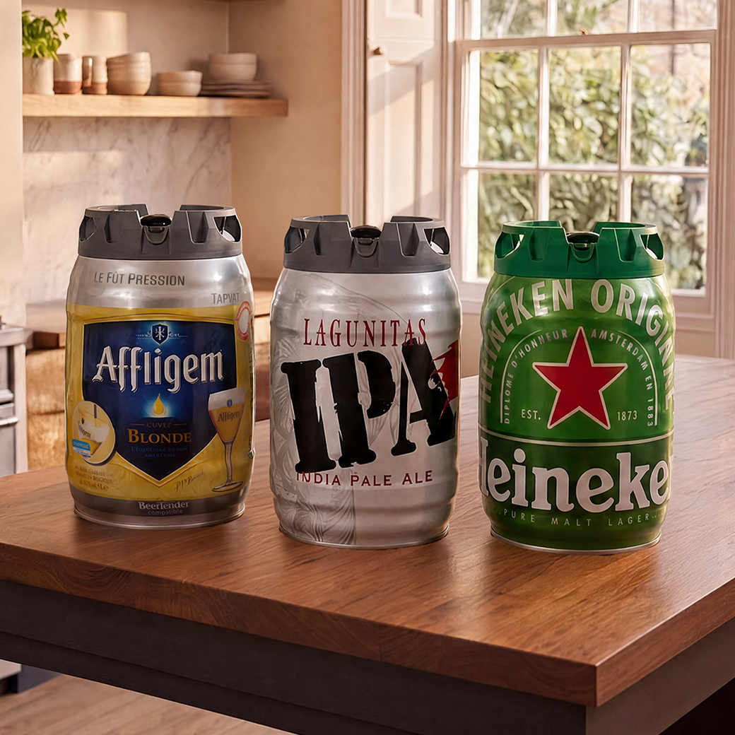 Three beer kegs labeled 'Affligem', 'Lagunitas IPA', and 'Heineken' on a wooden table.