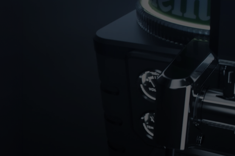 Close-up of a blade machine with Heineken logo on a dark background