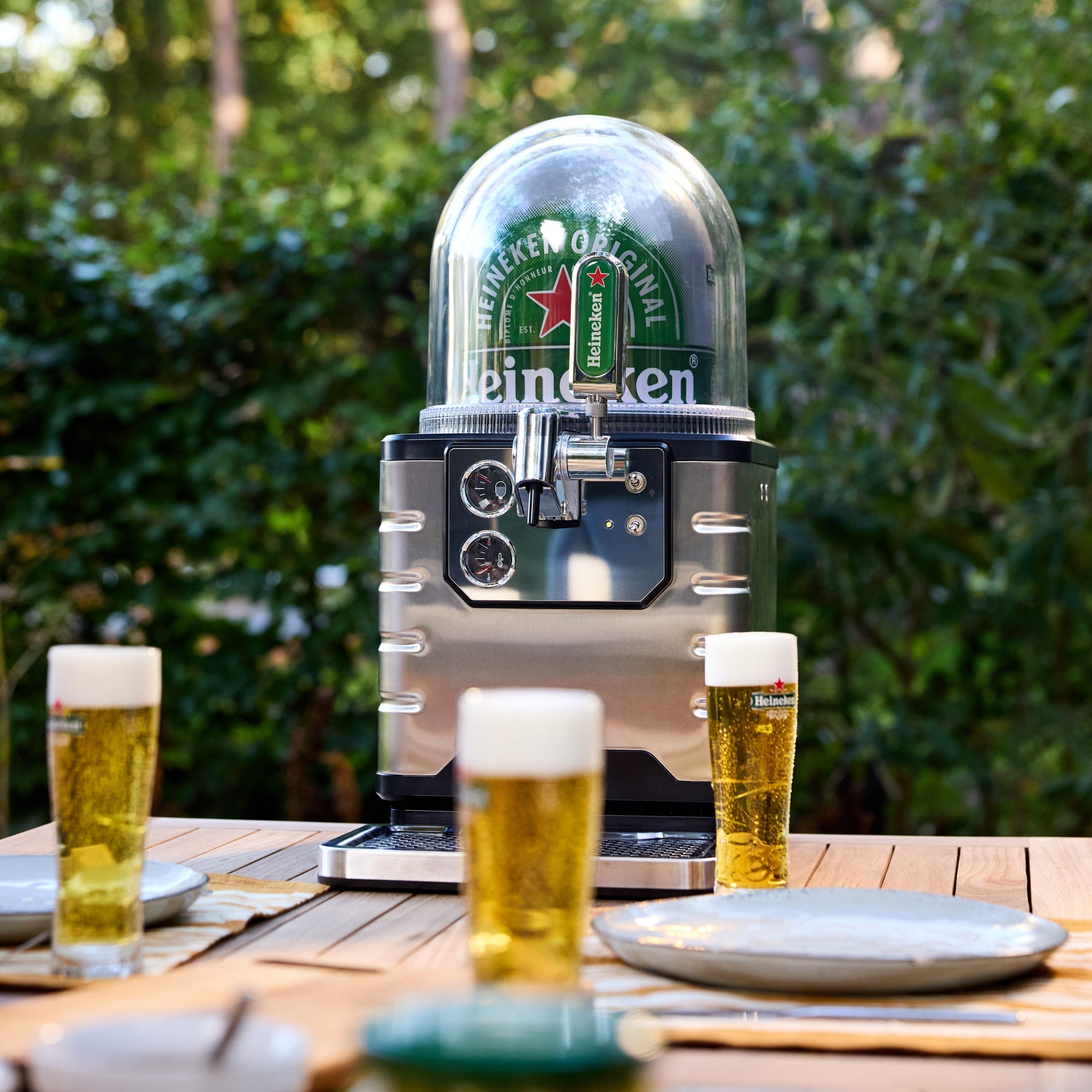 BLADE beer tap with glasses of beer on a wooden table outdoors.
