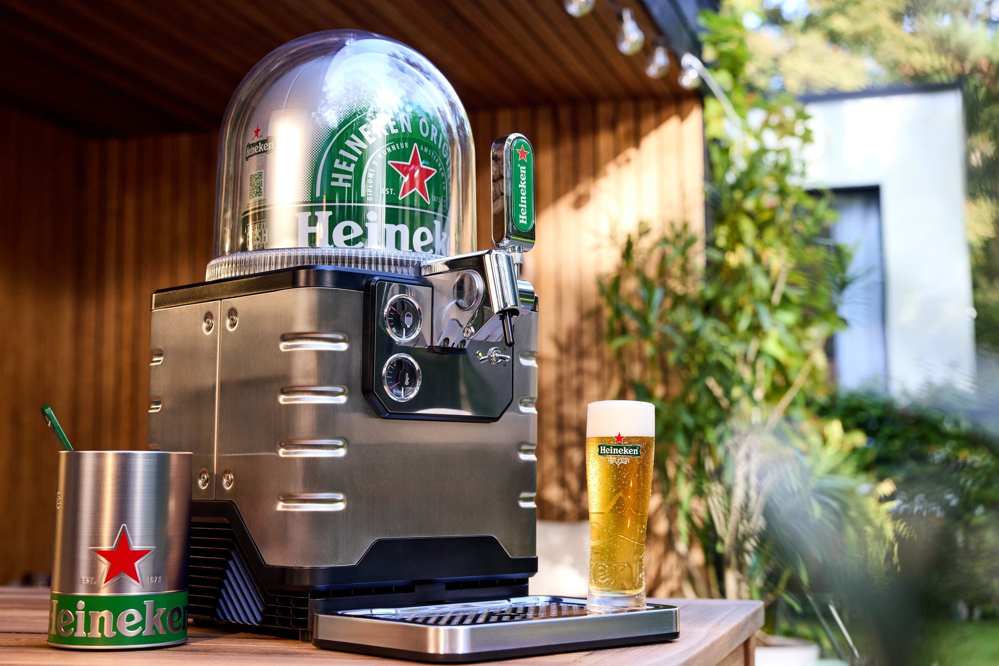 BLADE beer machine with Heineken keg on a wooden surface outdoors.