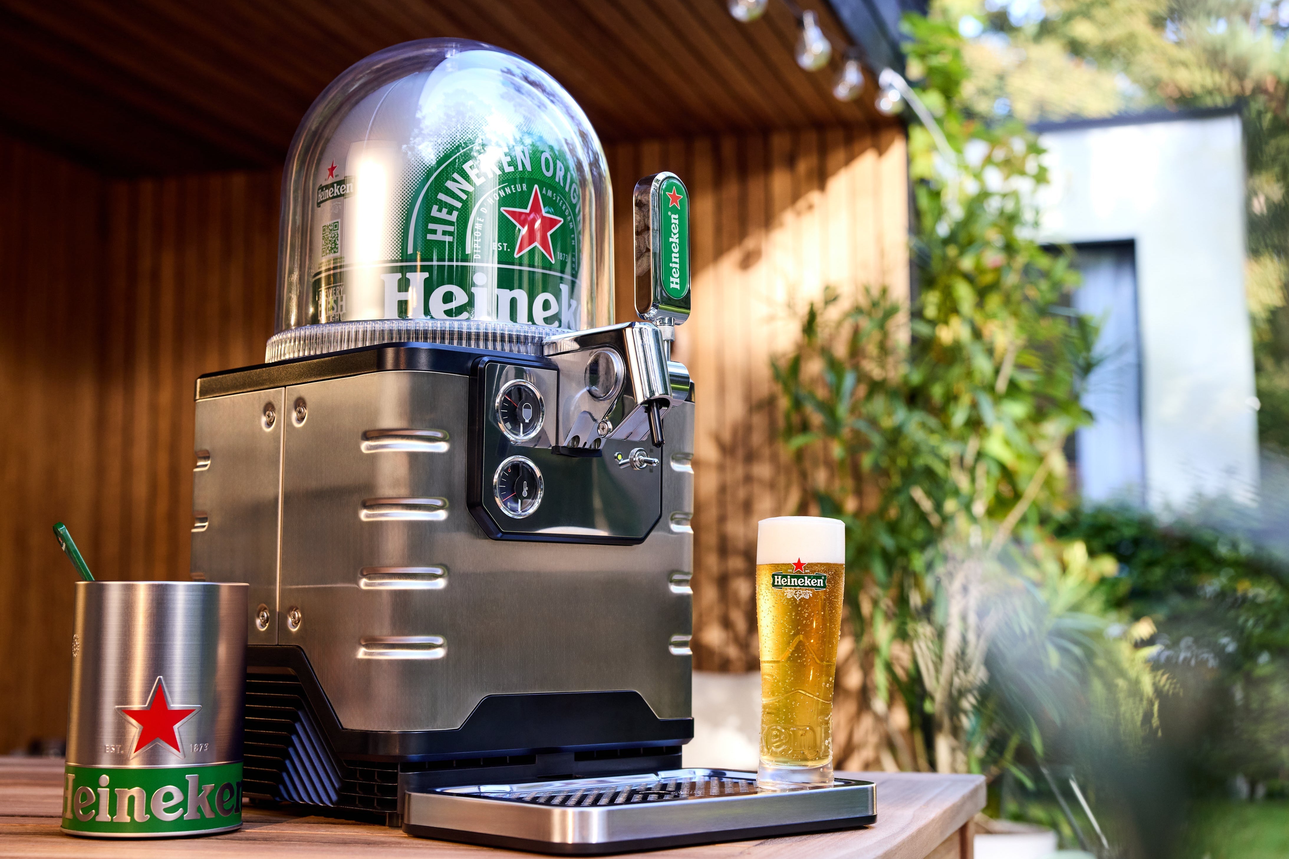 BLADE beer machine with Heineken keg on a wooden surface outdoors.