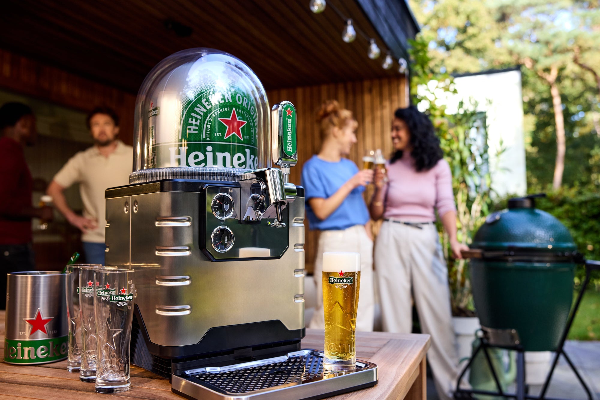 Heineken BLADE beer machine on a table with people in the background
