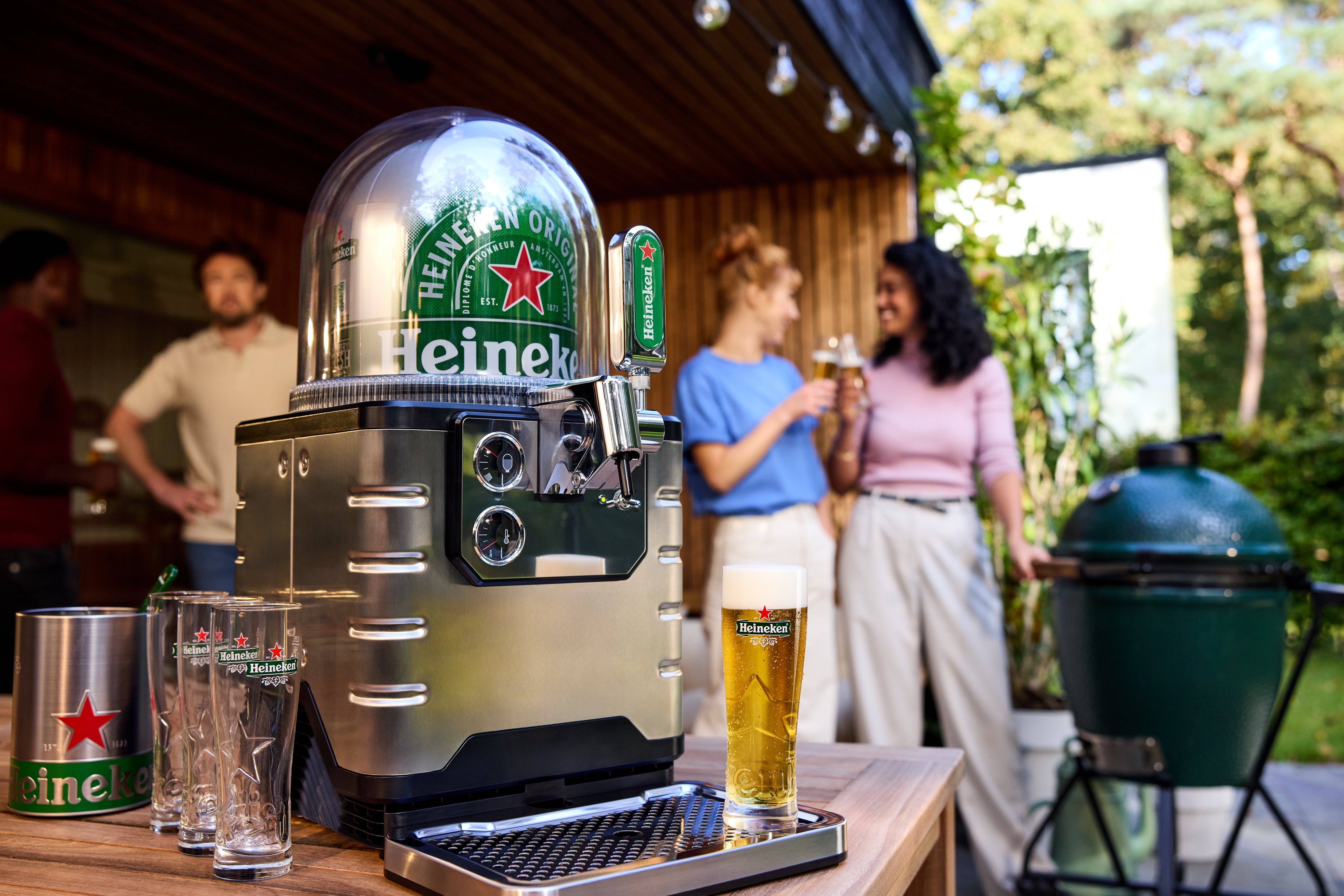 Heineken BLADE beer machine on a table with people in the background