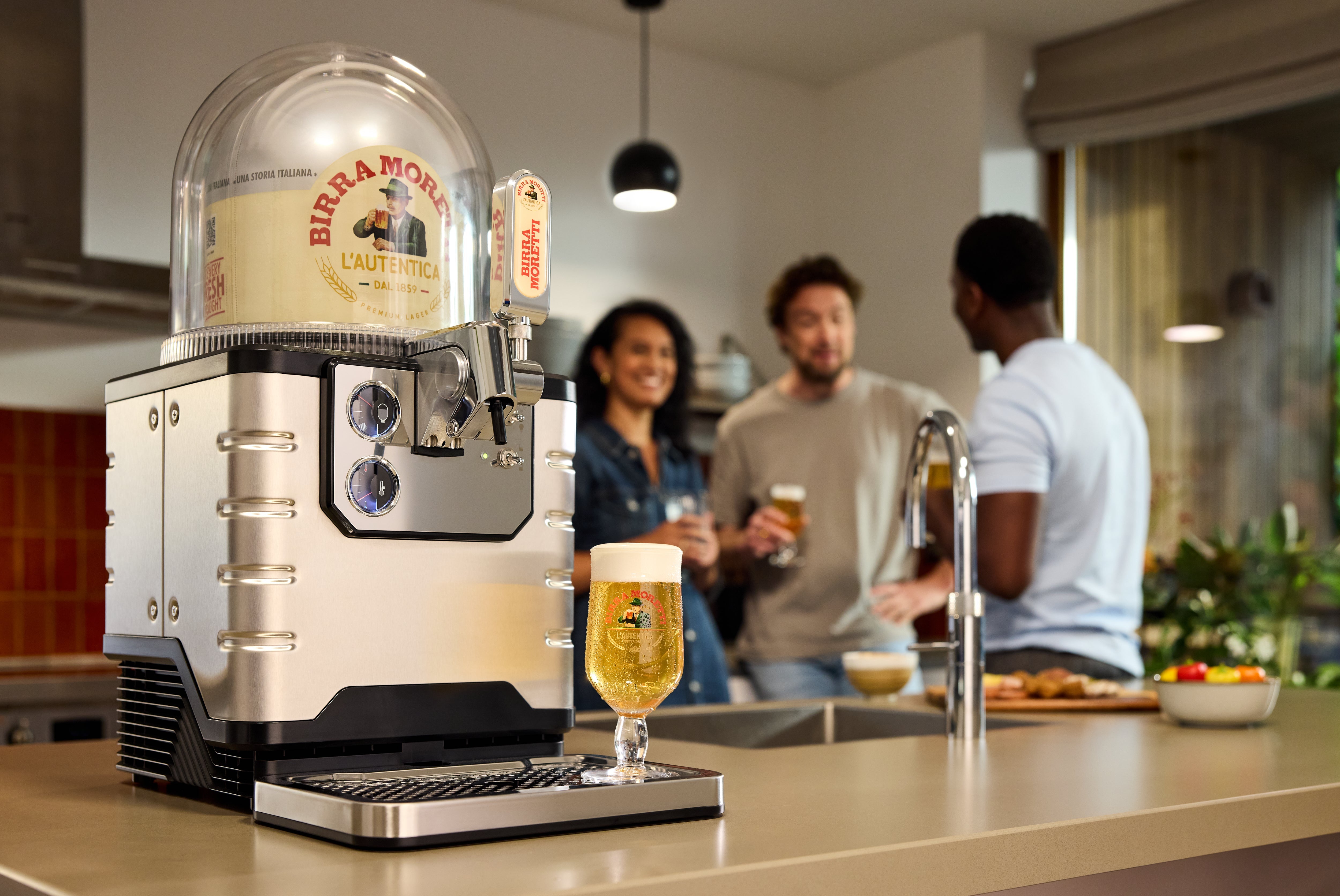 BLADE beer machine on a kitchen counter with people in the background