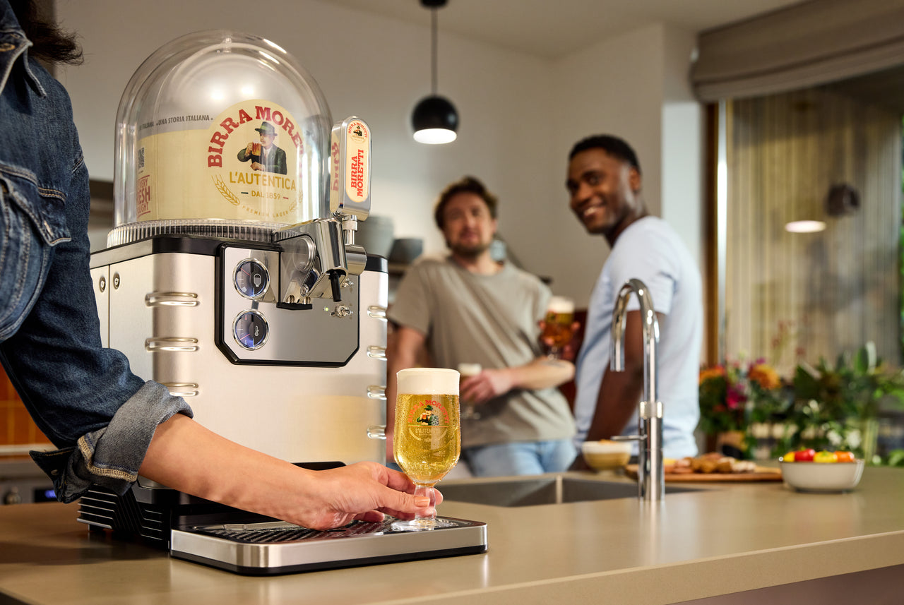 People Enjoying Birra Moretti from Blade Beer Tap in Modern Kitchen Setting.