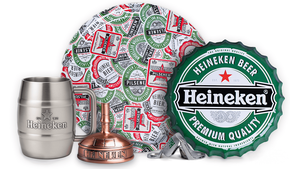 A collection of Heineken branded home bar accessories including a stainless steel mug, a metal wall bottle opener, a wall plate, a waiter tray, and a copper kettle bottle opener.