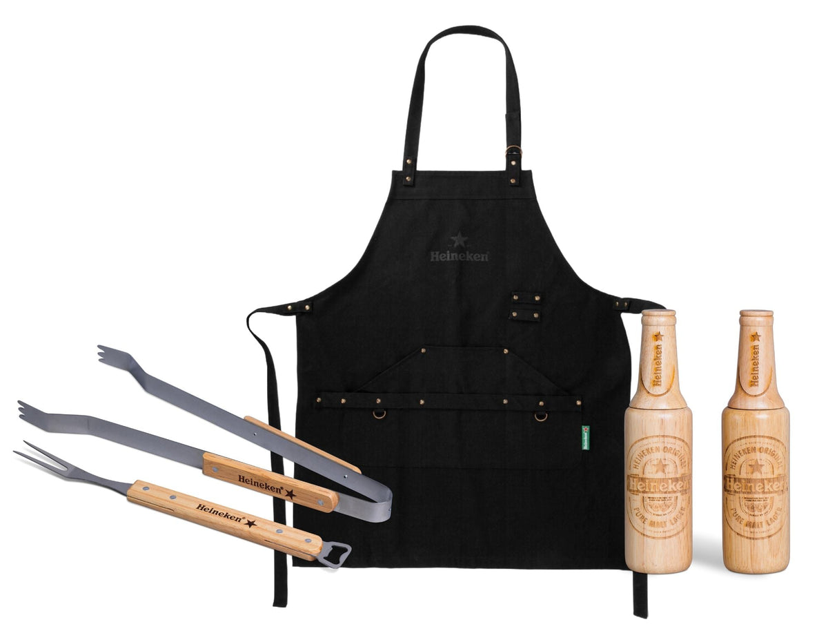 Black apron with grill tools and wooden bottles on a white background