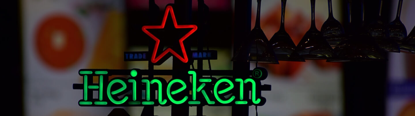 An LED neon sign of Heineken in green and the Heineken star in red