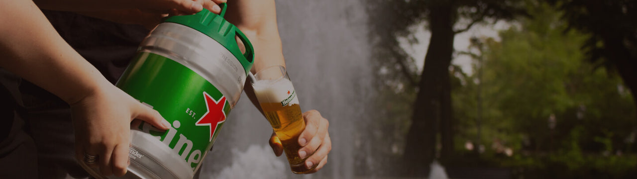 Two people pouring Heineken beer from a 5L Heineken draught keg