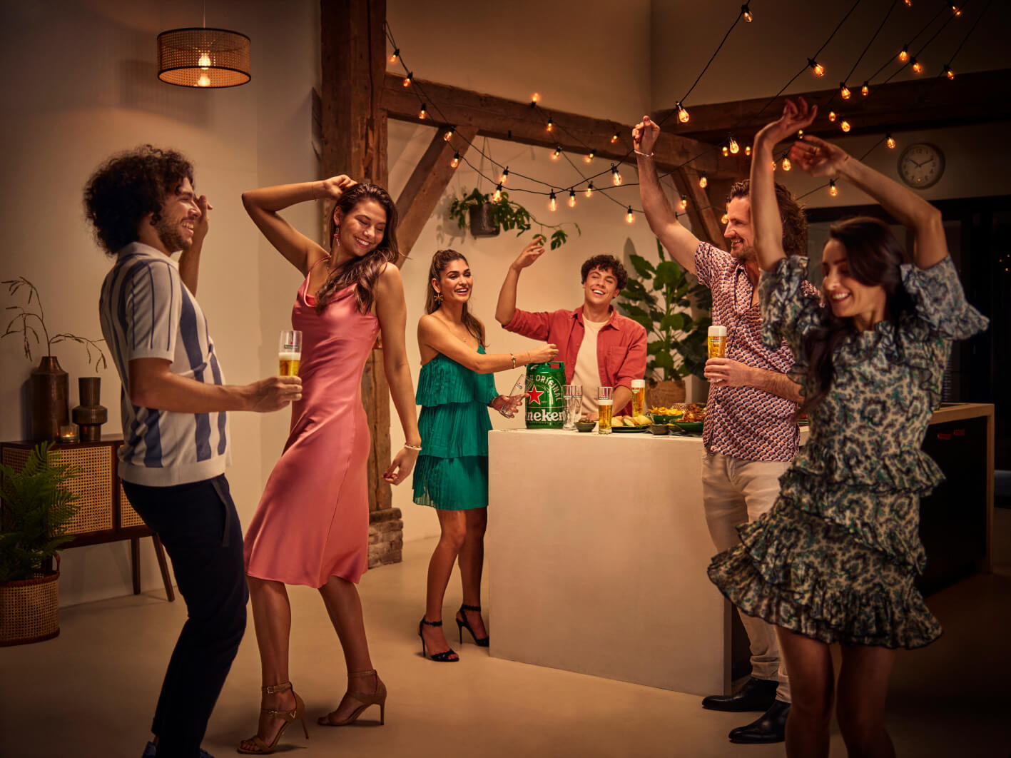 People at a house party dancing and drinking Heineken beer